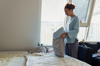 teenage girl, daughter washes bed, puts clean pillowcase on pillow, helps with routine housework