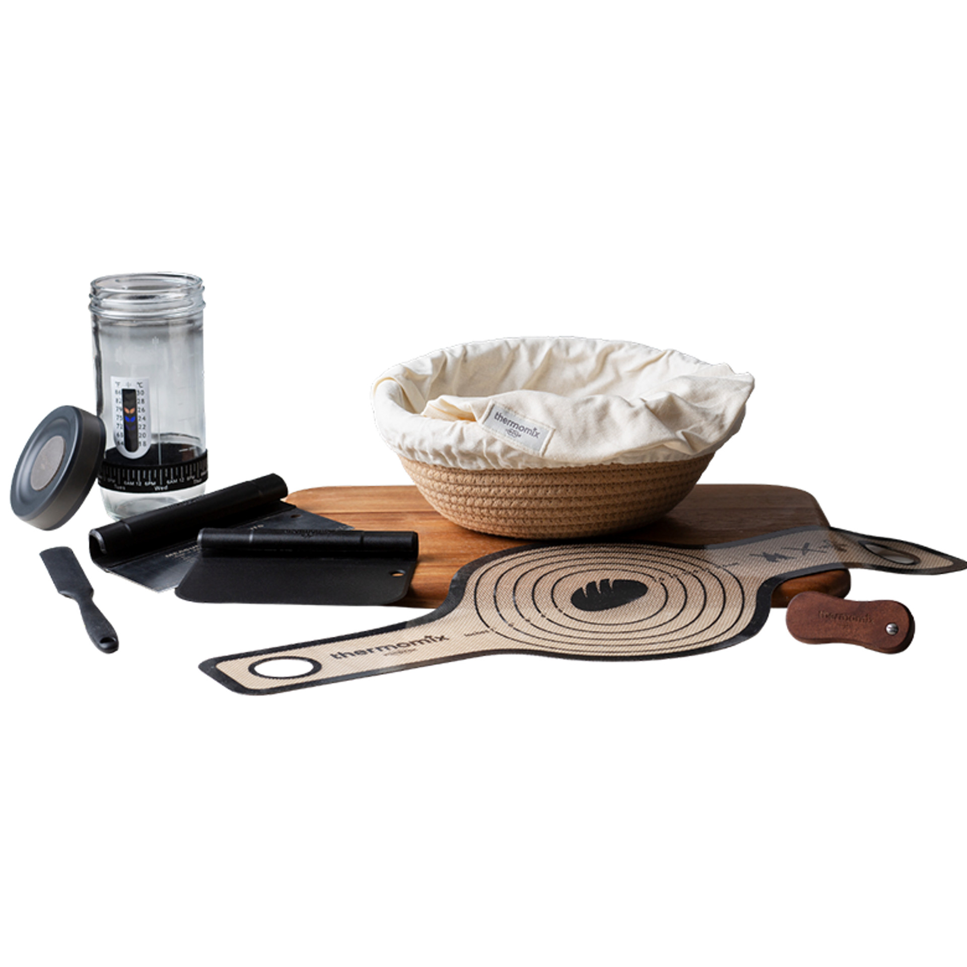 Kit de boulangerie avec banneton, bocal, tapis silicone, coupe-pâte, lame, planche et doublure en tissu.