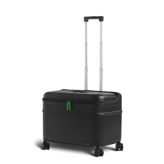 Black rolling suitcase with extended silver handle and green zipper pulls shown on four wheels