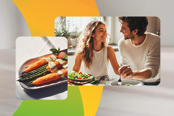 Paar isst Salat, daneben Teller mit Spargel und Sauce