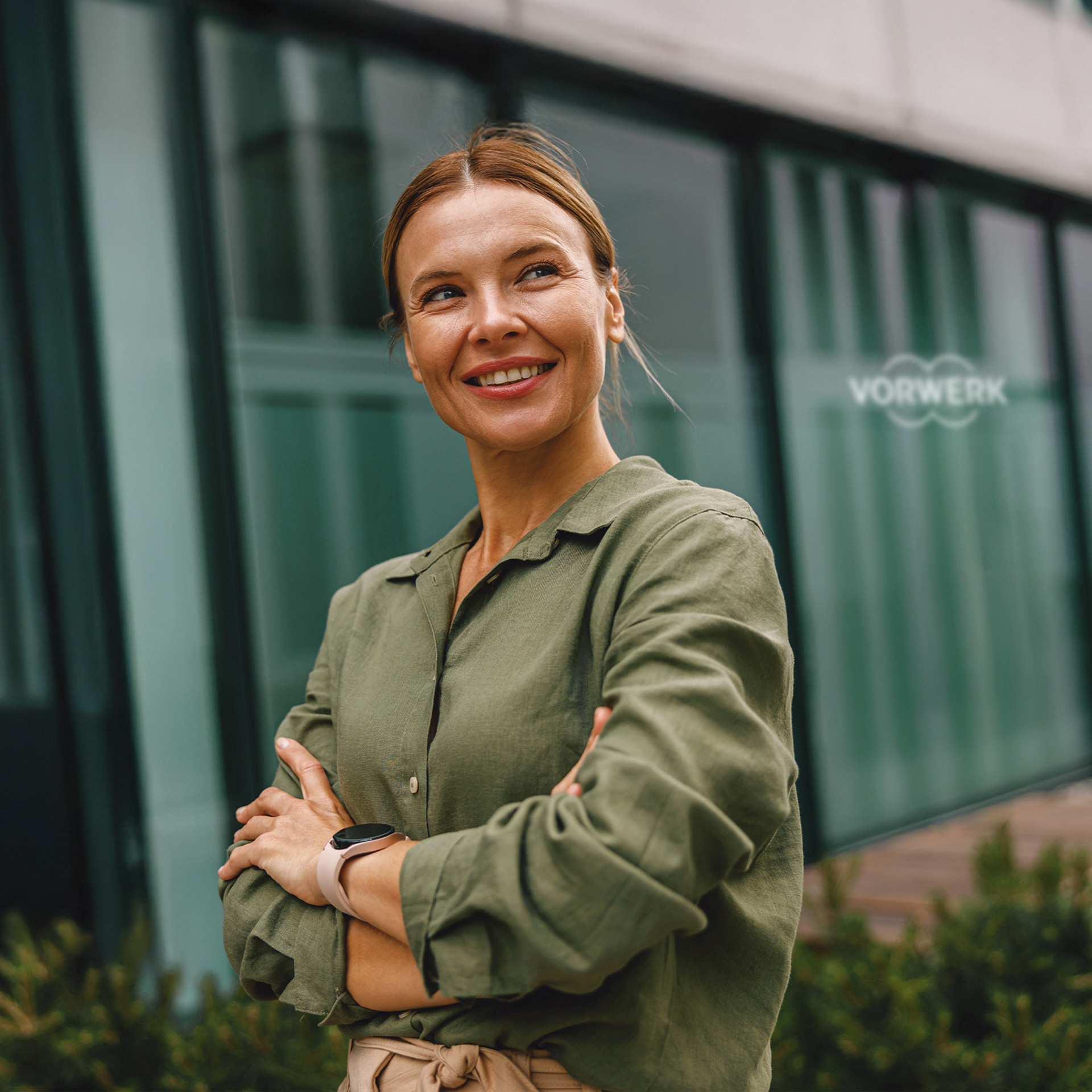 Selbstbewusste Mitarbeiterin vor Vorwerk-Zentrale