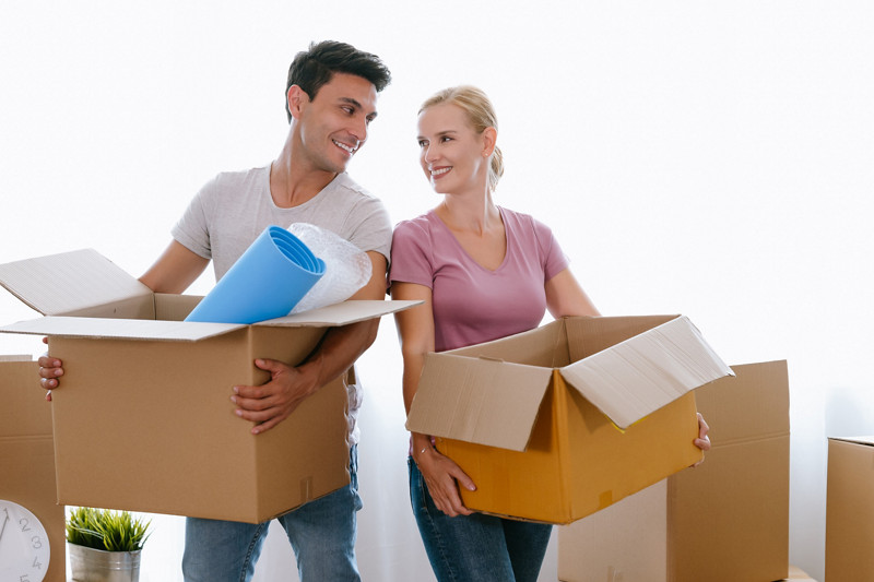 Portrait of happy middle age couple moving to a new house, holding cardboard boxing smiling happy in love with apartmant. Relocation, Renovation, Home and family concept