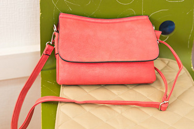 Pink women handbag in a clothing fashion store.