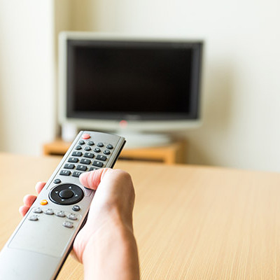 TV remote control in hand