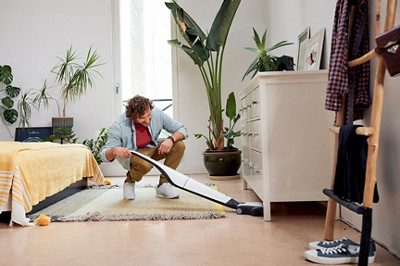 fr kobold vb100 in use man cleaning bedroom