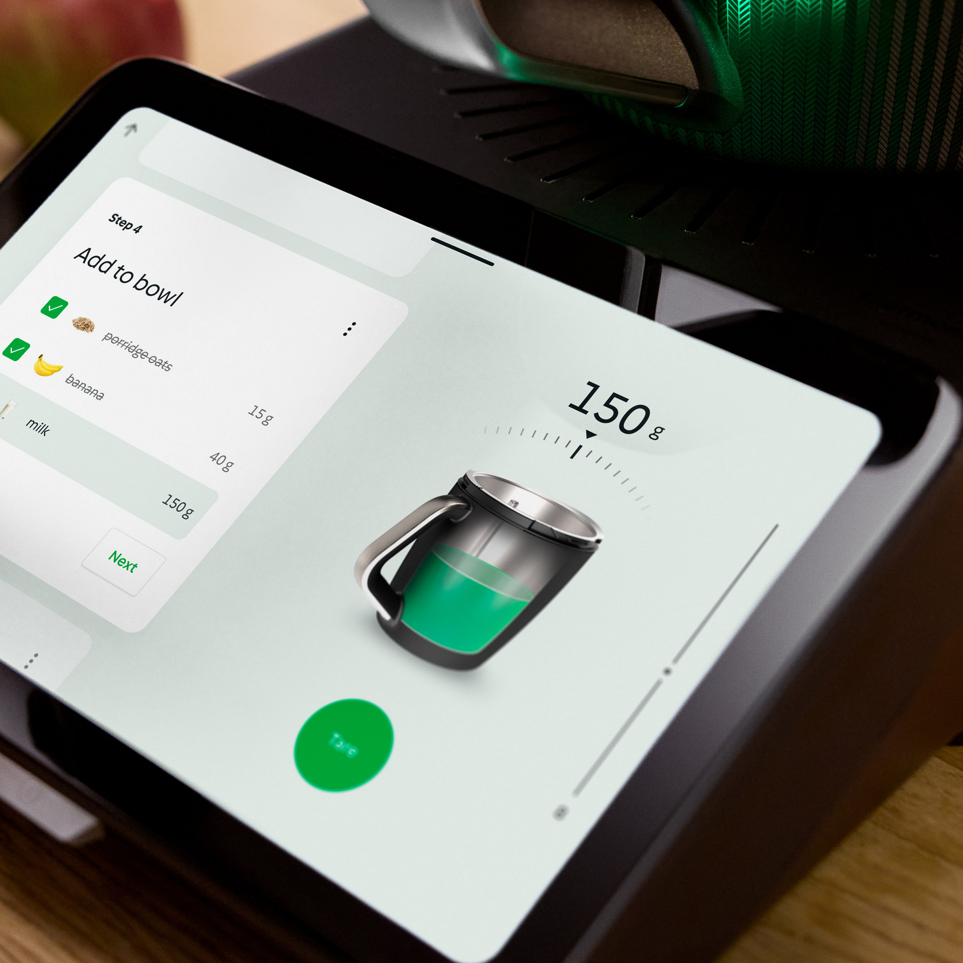Close-up of a hand selecting ingredients on the Thermomix® TM7 touchscreen, with fruit and the appliance visible in the background.