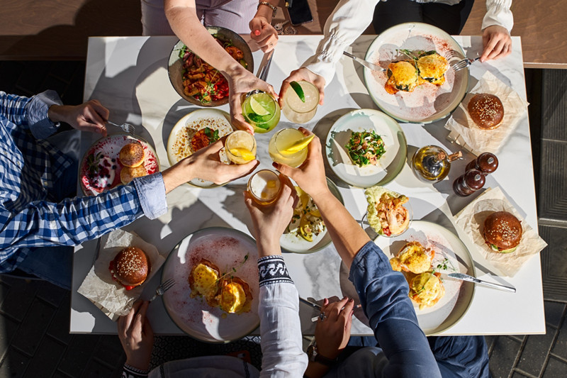 Group of happy friends having nice food and drinks, enjoying the party and communication, Top view of Family gathering together at home for eating dinner.