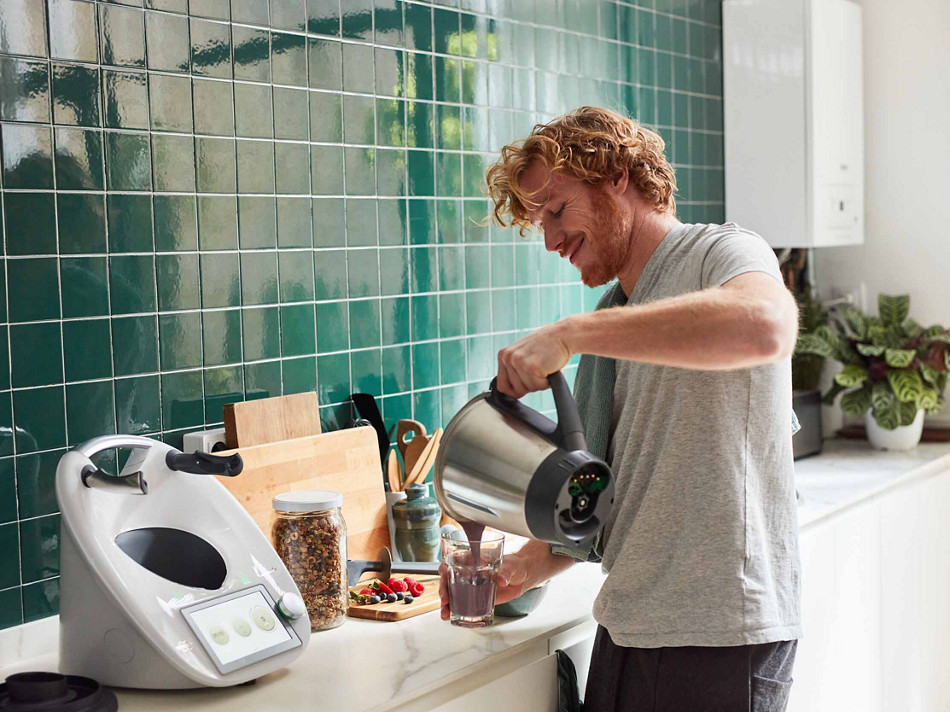 thermomix man with tm6 mixing kitchen