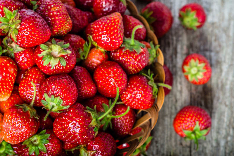 Fresh strawberries in the basket, fruits on farmer market table